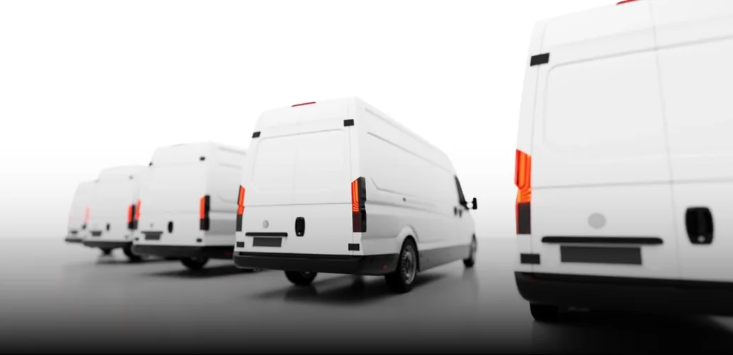 Line of unbranded white cargo vans representing a commercial delivery fleet